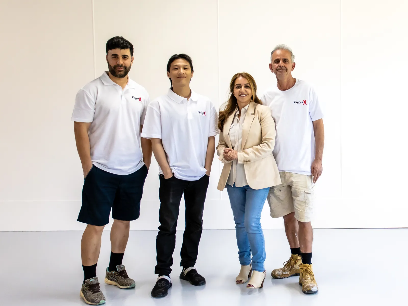 Affy Elzami with three of the PaintX painters in their PaintX shirts