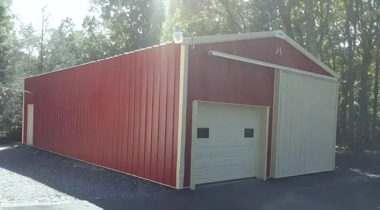 Large steel shed finished in red with cream trims and roller door